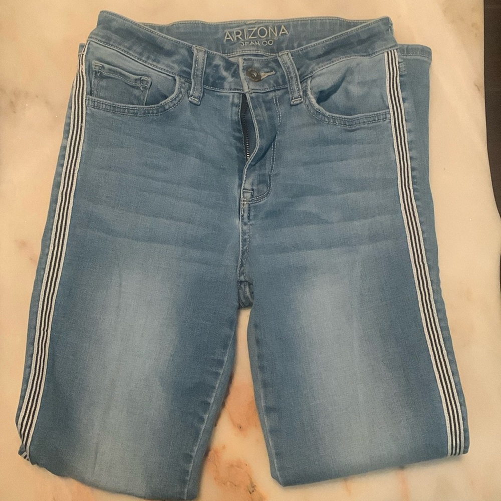 I am selling these cute light blue jeans with black white striped designs!!